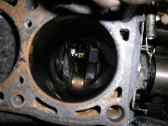 Close-up of an engine cylinder head with a visible cylinder bore