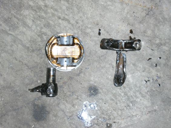 Two engine parts on a concrete surface