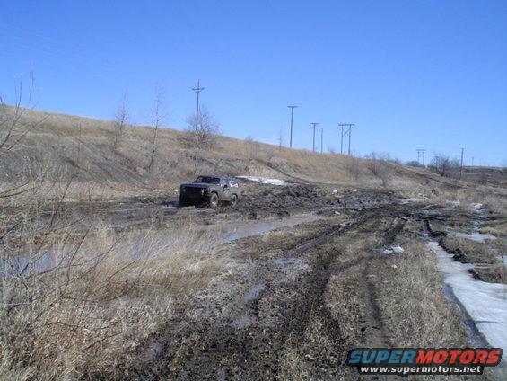 1981 Ford Bronco navigating a muddy off-road course