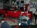 1978 Ford Mustang II - A red 1978 Ford Mustang II, identified by its "KING COBRA" badging, is shown in a garage with its engine being removed by an engine hoist.