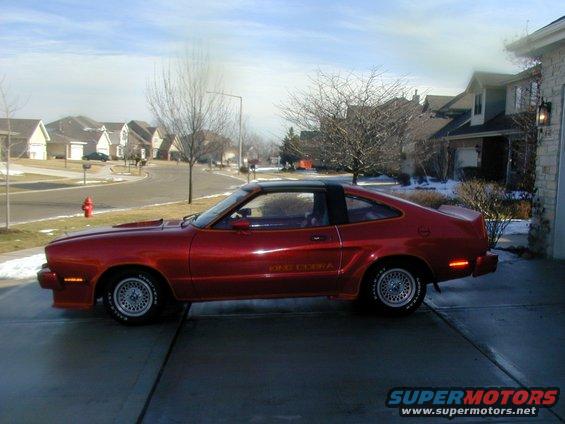 Red 1978 Ford Mustang II coupe with black t-top and "KING COBRA" decal on the side