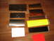 2002 Ford Taurus - Swatches of reflective material laid out on a wooden surface. Includes diamond plate, yellow, black, white, and metallic finishes.