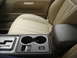 2002 Lincoln Town Car - Interior view of a car's center console and front seats, leather upholstery and cup holders.