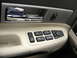 2002 Lincoln Town Car - Close-up of a car's interior door panel, showing the window and mirror controls.