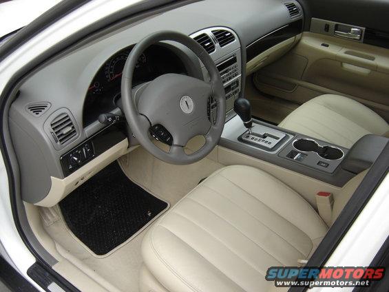 Interior view of a 2002 Lincoln Town Car showing dashboard, steering wheel, center console, and front seats