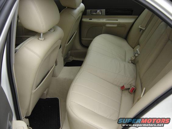 Back seat and door panel of a car with tan leather seats