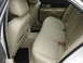 2002 Lincoln Town Car - The interior of a car shows the rear seating area and door panel with tan leather upholstery.