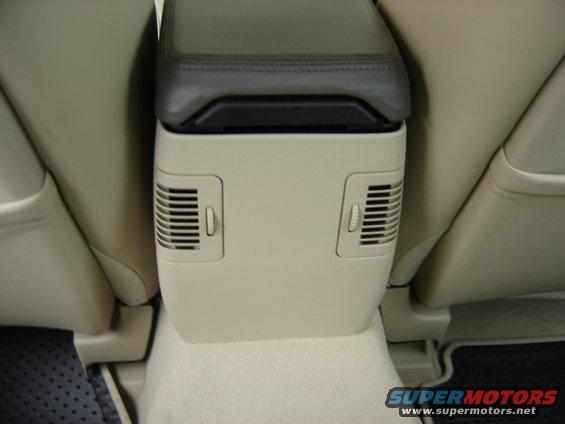 Center console with dual air vents and leather-trimmed armrest