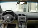2002 Lincoln Town Car - Interior view of a car's dashboard, steering wheel, and gear shifter, with a garage door in the background.