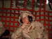 1988 Ford Bronco - A person in desert camouflage attire with headphones sits inside a cargo net, appearing to be in an aircraft.