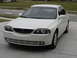 2002 Lincoln Town Car - This white sedan, likely from the early 2000s, is shown from a 3/4 front angle.