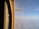 1988 Ford Bronco - Airplane wing visible through the cabin window during flight.