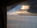 1988 Ford Bronco - Looking out the window at the clouds and an airplane engine pod.