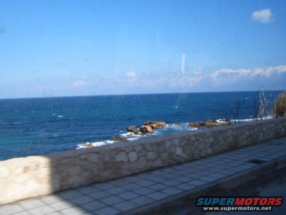 Ocean view with rocky shore and stone wall