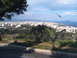 1988 Ford Bronco - Panoramic view of a coastal city with buildings reaching towards the sea.
