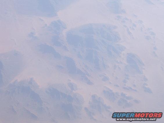 aerial view of desert terrain with hazy sky