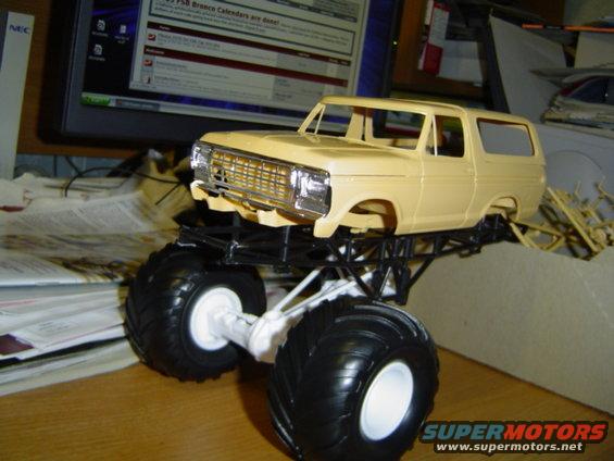 model monster truck with large tires, sitting on a desk