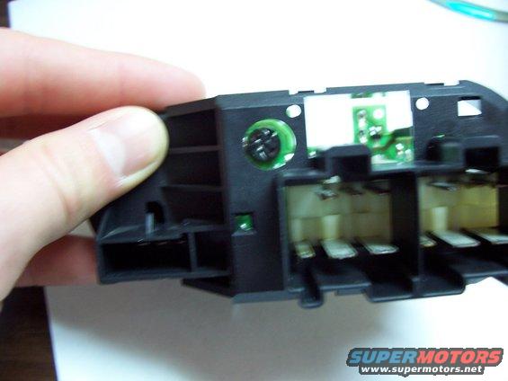 light_switch5.jpg back of the switch, looking thru the hole where you unscrew the bulb from. flat head screw driver works best, of course.