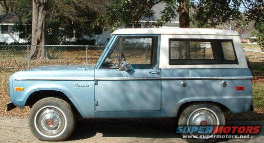 Side view of a light blue 1974 Ford Bronco with a white hardtop