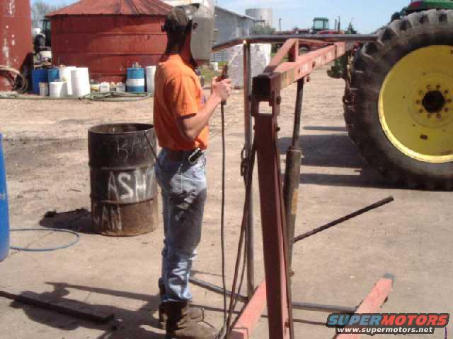I used an engine hoist to spread the legs of the main hoop. Completed  the welds after measuring and checking square w/ main hoop.
