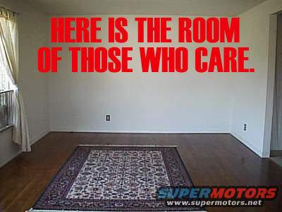 Interior room with a rug on the floor and red text on the wall reading 'HERE IS THE ROOM OF THOSE WHO CARE.'