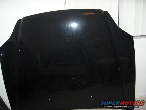 Black car hood with scratches, viewed from the front