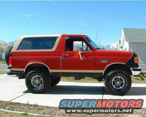 1990 Ford Bronco, red with tan top, side view, lifted suspension