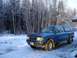 1994 Ford Ranger - This blue 1994 Ford Ranger pickup truck is parked in a snowy landscape with frosted trees in the background.