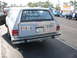 1997 Ford Crown Victoria - A station wagon is parked in a lot, with writing on its rear window and a license plate.