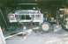 1978 Ford Bronco - This 1978 Ford Bronco is in a garage, elevated on jack stands with its front end disassembled for repairs.