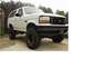 1992 Ford Bronco - This lifted 1992 Ford Bronco features a prominent black grille and aggressive tires, suggesting off-road capability.