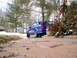 2003 Mazda Protege - Rear view of a blue 2003 Mazda Protege sedan parked on a brick driveway in a residential area.