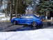 2003 Mazda Protege - A blue sedan with a spoiler is parked outside in a snowy environment.