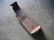 1994 Ford Bronco - This is a metal bracket, likely a vehicle part, shown on a concrete surface.