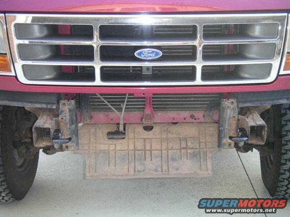 Red 1994 Ford Bronco front grille with chrome accents and tow hooks