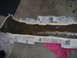 1994 Ford Bronco - A car bumper is masked with newspaper and tape, likely for repair or painting.