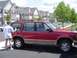 1992 Ford Explorer - Red 1992 Ford Explorer SUV parked in front of townhouses, woman washing the side.