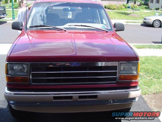 Front view of a red 1992 Ford Explorer with a chrome grille