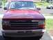 1992 Ford Explorer - The front grille of a red 1992 Ford Explorer is visible, with a person standing behind it.