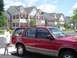 1992 Ford Explorer - A red 1992 Ford Explorer is parked in front of a row of townhouses on a sunny day.
