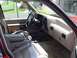 1992 Ford Explorer - The interior of a car shows tan leather seats, dashboard, and center console.