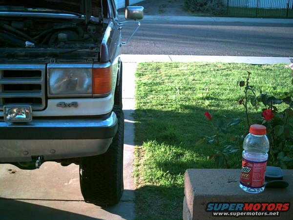 1988 Ford Bronco front end with hood open, showing 4x4 badge