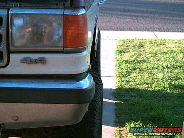 Front fender and headlight of a 1988 Ford Bronco with 4x4 badging