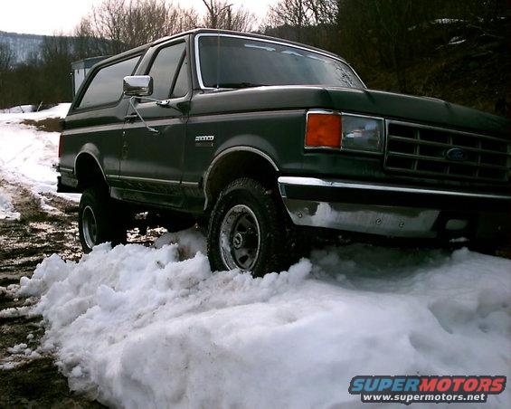 Dark green 1988 Ford Bronco in snow, 3/4 front view