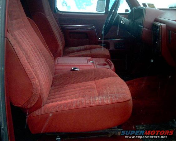 Red fabric bucket seats and center console of a 1988 Ford Bronco