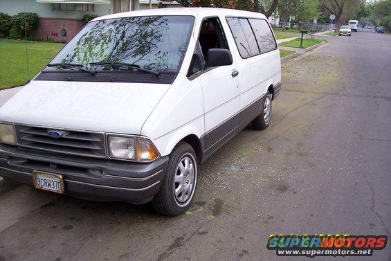 White Ford Aerostar van parked on a residential street. License plate reads 3CRW370
