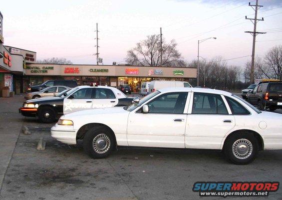 The Car next to a JUSTICE pd cruiser.