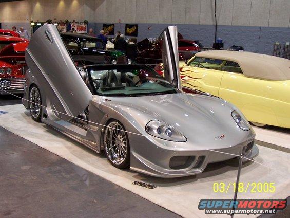 Silver convertible with butterfly doors and custom body kit