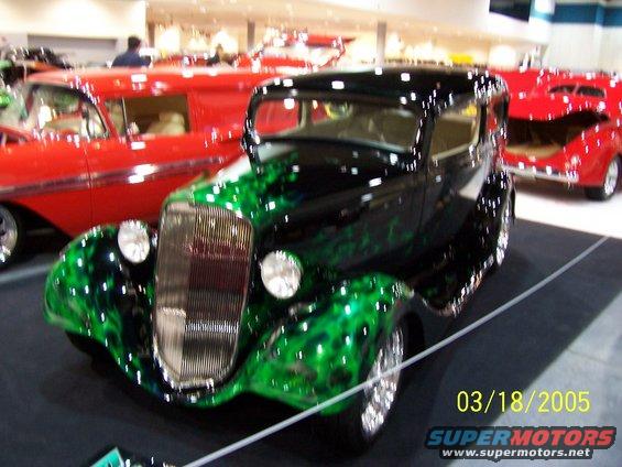 Black hot rod with green flames, front three-quarter view, chrome grille, visible date 03/18/2005