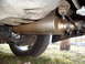 1993 Ford Probe - Undercarriage view showing the exhaust system and a tire. The registry claims this is a 1993 Ford Probe, but the image does not provide eno…